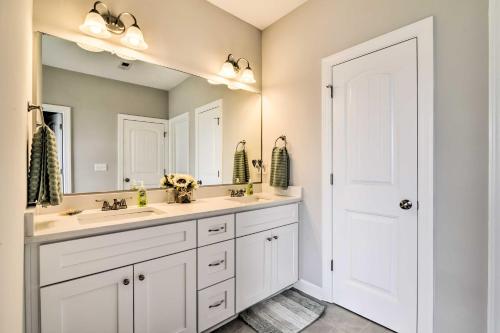 a bathroom with two sinks and a large mirror at Waterfront Paradise with Deck about half Mi to Beach in North Camellia Acres