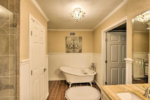 a bathroom with a tub and a sink and a shower at Pet-Friendly Home about 6 Mi to Downtown Fort Worth! in Fort Worth