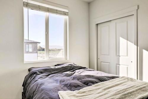a bedroom with a bed and a window at Modern Townhome - 8 Mi to Thanksgiving Point! in American Fork