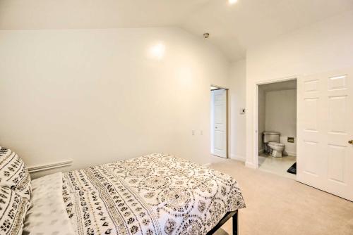 a bedroom with a bed and a bathroom with a toilet at Cozy Redmond Retreat Spacious Deck and Yard! in Redmond