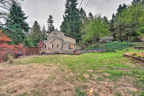 an old house in the middle of a yard at Cozy Redmond Retreat Spacious Deck and Yard! in Redmond