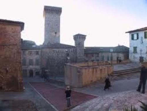 a group of people walking around in an old building at Favolosa Villa in Toscana in Lucignano
