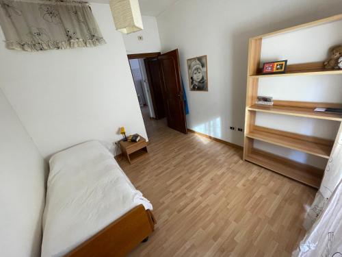 a bedroom with a bed and a wooden floor at Tat@Flat in Rome