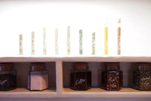 a shelf with several jars of spices on it at Apartment Belvedere in Caines