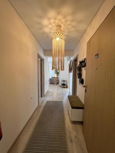 a hallway with a chandelier on the ceiling at McRamé Design Apt Sea View, Beachfront, Swimming Pool, 2BDR, 2BAR, 6 pax, Praia da Rocha in Portimão