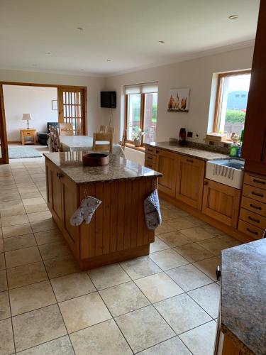 a kitchen with an island in the middle of a room at Hen Pen in Montrose
