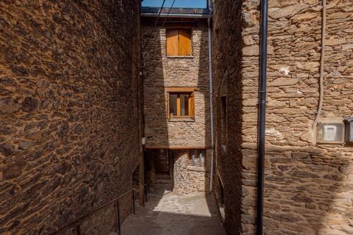 an alley in an old stone building at Casa Xaupí Gran in Roní