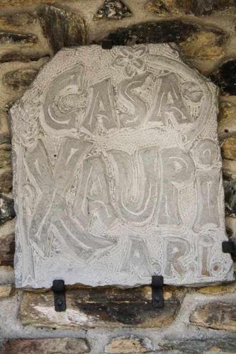 a stone sign on the side of a stone wall at Casa Xaupi 1 in Roní