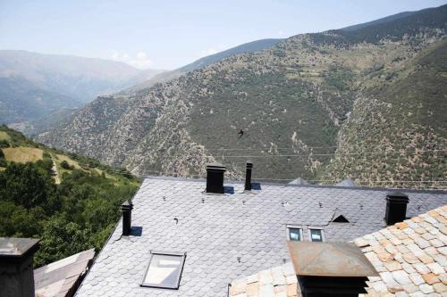 a roof of a house with mountains in the background at Casa Xaupi 1 in Roní