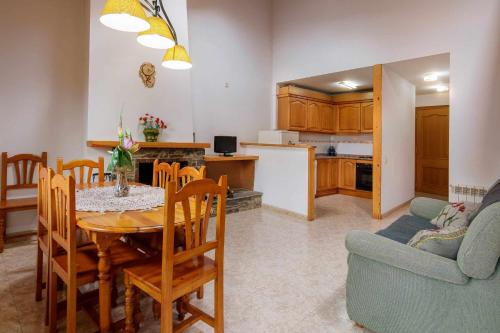 a kitchen and living room with a table and a couch at Casa Xaupi 1 in Roní