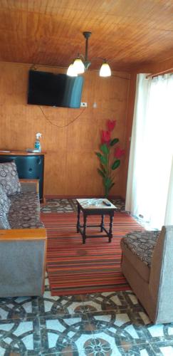a living room with a couch and a table at cabañas Te Pito Kura in Hanga Roa