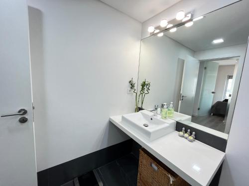 a bathroom with a white sink and a mirror at Cliffs Apartment - Astonishing view over Sesimbra bay by Trip2Portugal in Sesimbra