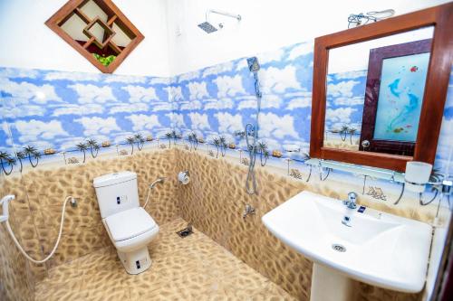 a bathroom with a toilet and a sink at Heritage villa polonnaruwa in Polonnaruwa