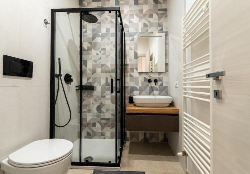 a bathroom with a shower and a toilet and a sink at SAN BARTOLOMEO BAROQUE in Scicli