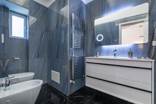 a black and white bathroom with a sink and a mirror at Prezioso suites & rooms in Lecce