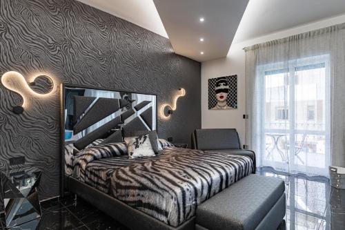 a bedroom with a bed and a window at Prezioso suites & rooms in Lecce