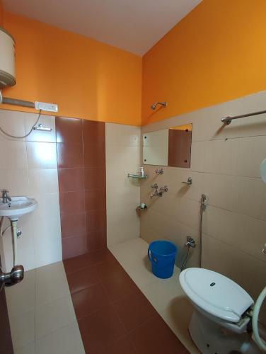 a bathroom with a toilet and a sink at Hotel La Casa in Namchi