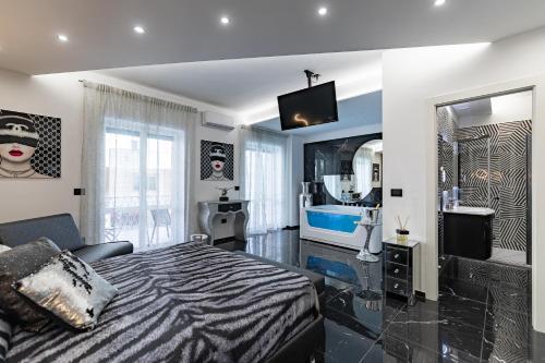 a bedroom with a bed and a large mirror at Prezioso suites & rooms in Lecce