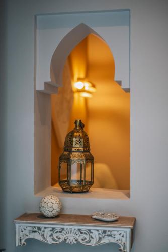 a lantern sitting on a table in a room at Apartamentos Turísticos La Baílla in Rota