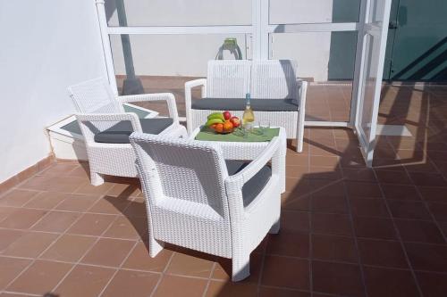 uma mesa com cadeiras e frutas numa varanda em Casa Amanecer em Abades