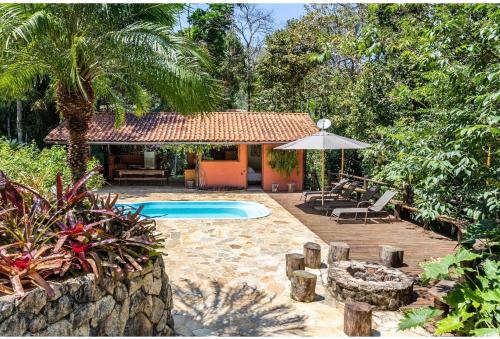 un patio trasero con piscina y una casa en Tékinfin, você chegou! Lindo sítio em Secretário! en Petrópolis