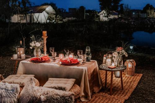 a table set up for a wedding with candles and flowers at Salterra Glamping in Tequisquiapan