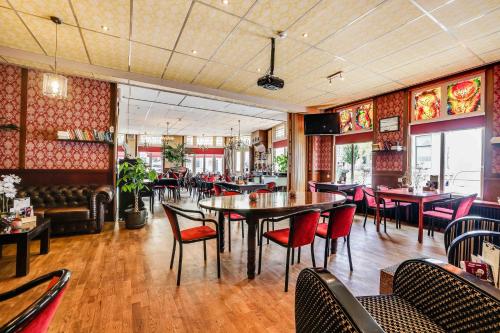 a restaurant with tables and chairs in a room at Hotel Restaurant 't Heerenlogement in Harlingen