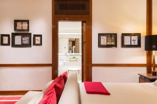 a bedroom with a bed with a red towel on it at Portrait Milano - Lungarno Collection in Milan
