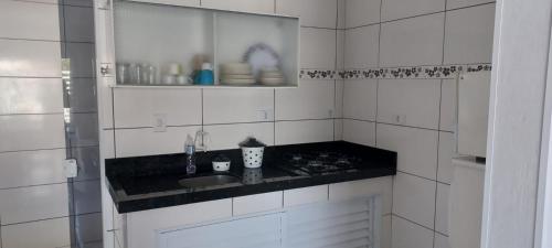 a kitchen with a sink and a counter top at Beach House in Penha