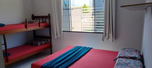 a bedroom with two bunk beds and a window at Beach House in Penha