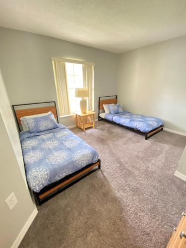 a bedroom with two beds and a window at DWS Vacation Villas in Orlando