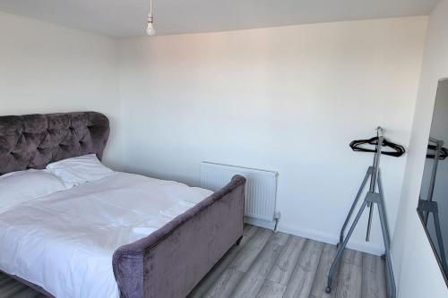 a bedroom with a bed with a tripod and a camera at Newly refurbished 3 bedroom flat in Bedworth