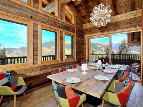une salle à manger avec une table, des chaises et des fenêtres dans l'établissement Chalet d'Exception avec Sauna et Cheminée - 12 Pers, 6 Pièces - FR-1-575-32, à Courchevel