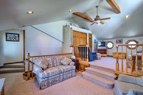 a living room with a couch and a ceiling fan at Waterfront Home on Lake George with Boat Dock! in Queensbury