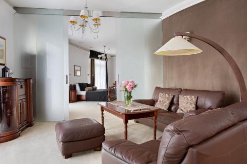 a living room with a couch and a table at Hotel Olympic Spa & Wellness in Ustroń