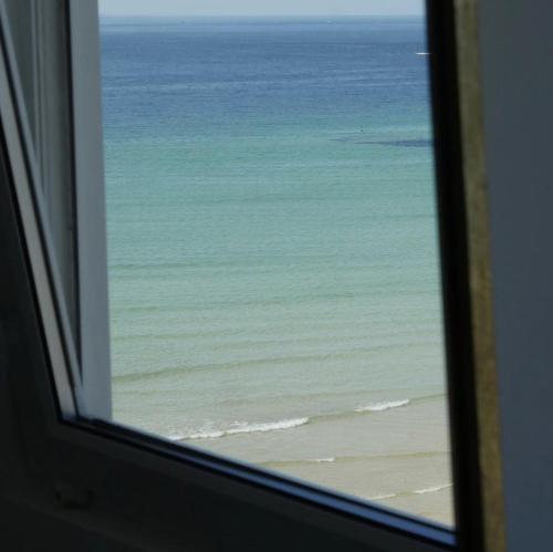 a view of the ocean from a window at Harbour View House in St Ives