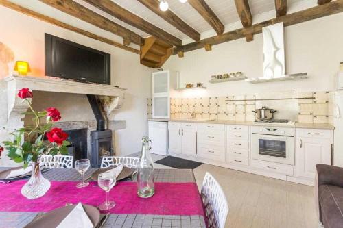 une salle à manger avec une table et une cheminée dans l'établissement Gîte des remparts, à Bèze