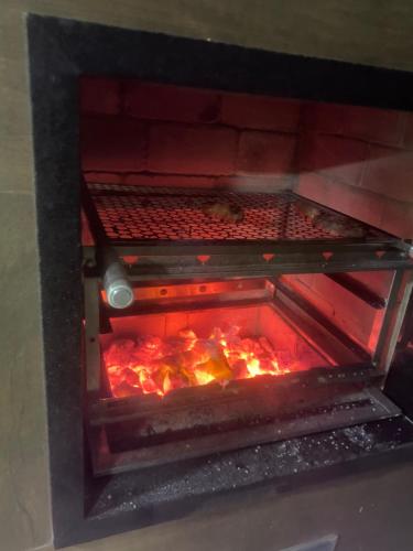 un forno aperto con cibo in esso di Lis zen suite 02 a Porto De Galinhas