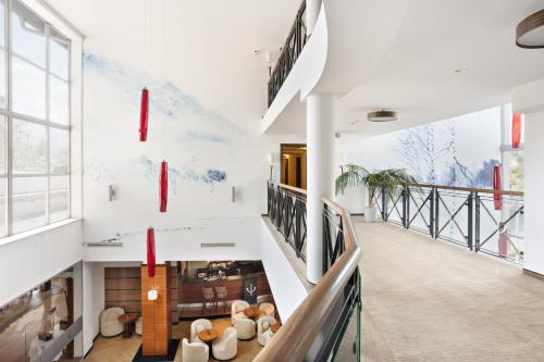 a staircase in a building with a mural on the wall at Hotel Olympic Spa & Wellness in Ustroń