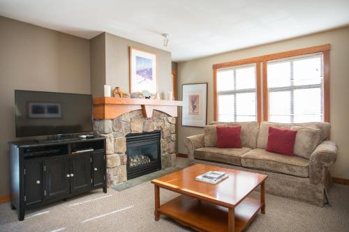 a living room with a couch and a fireplace at 1202 - Two Bedroom Standard Eagle Springs West condo in Solitude