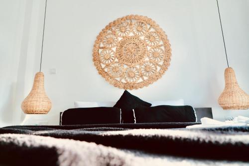 a bedroom with a bed and two pendant lights at The Jini House in Ahangama