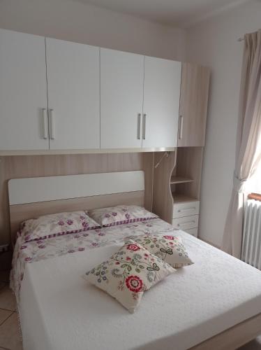 a bedroom with a bed with two pillows on it at Casa Barbóla in Sondalo