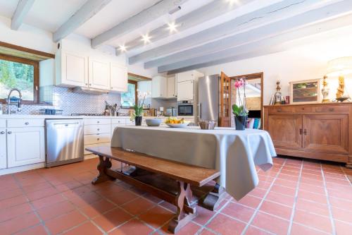 a kitchen with a table in the middle of it at Kerguestenen in Inguiniel