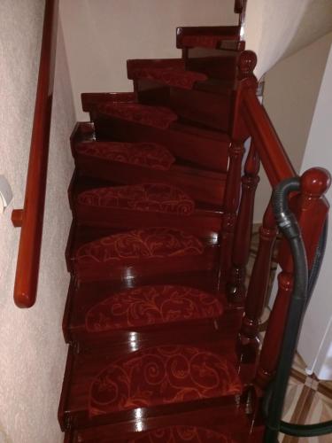 a set of stairs with red treads at Pensiunea Floare de Bucovina in Frasin