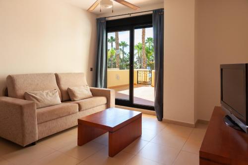 a living room with a couch and a coffee table at Apartamentos Playamarina in Isla Canela