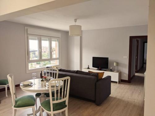 a living room with a couch and a table at Apartamento Sanfuentes Bat in Sanfuentes