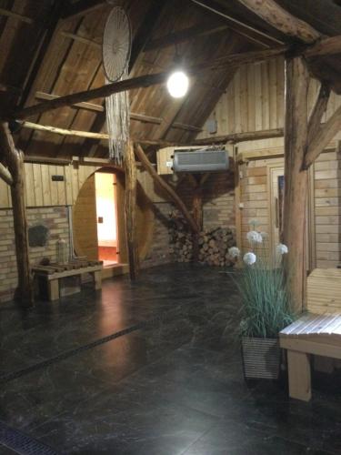 a large room with a ceiling with wooden beams at Chutor Grzegorza in Wysowa-Zdrój