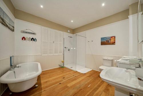 a bathroom with two sinks and a shower at Serviced Apartments Macclesfield in Macclesfield