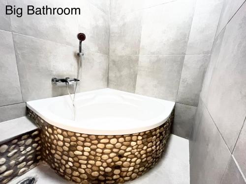 a bathroom with a bath tub with a sink at GKK House private swimming pool luxury house in Skriperón