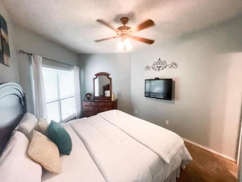 a bedroom with a bed and a ceiling fan at Our Happy Place in New Braunfels
